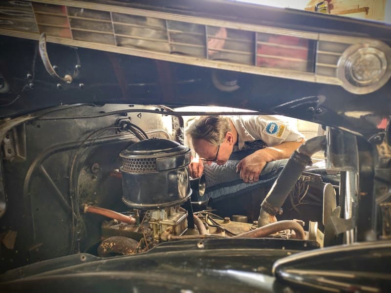 Professional mechanic working on vehicle engine